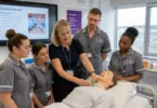 Health Lecturer teaching nursing students in a healthcare classroom at SGS College in Bristol.