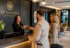 Hotel receptionist welcoming guests at Dakota Hotel Newcastle reception desk.